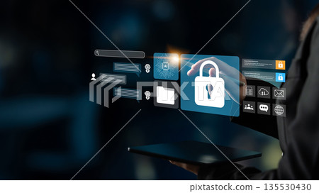 Modern Cybersecurity Concept with Digital Lock Icon, Data Protection Symbols, and Human Interaction in Futuristic Virtual Interface Gantry Modern Cybersecurity Concept with Digital Lock Icon, Data Protection Symbols, and Human Interaction in Futuristic Virtual Interface Gantry 135530430