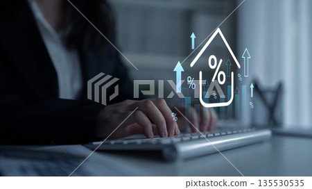 Business professional working on a computer while analyzing property market trends using data visualization and graphics representing growth indicators Gantry 135530535