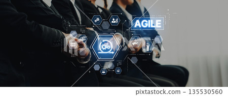 Professional Team Engaged in Agile Methodology Training with Digital Interface Representing Project Management Concepts and Collaboration Techniques Trope Professional Team Engaged in Agile Methodology Training with Digital Interface Representing Project Management Concepts and Collaboration Techniques Trope 135530560