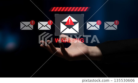 Warning Icon on a Digital Screen with Hand Reaching Out Representing Caution and Alertness in Cybersecurity and Risk Awareness Context Gantry 135530606