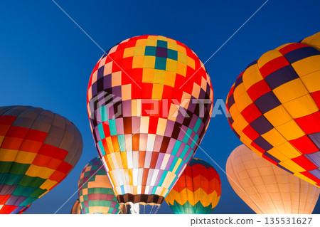 colorful hot air balloons glowing against sky 135531627