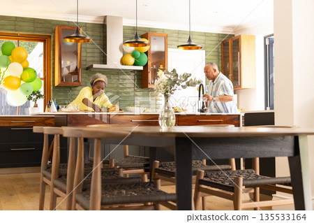 In modern kitchen, senior couple preparing meal, sharing each other's company 135533164