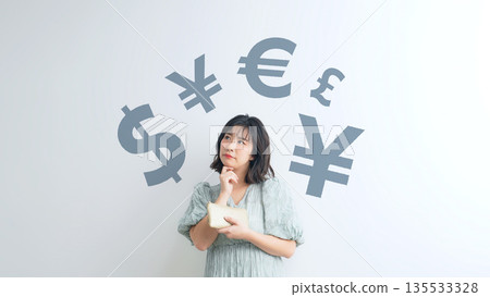 A woman holding a wallet and thinking about money 135533328