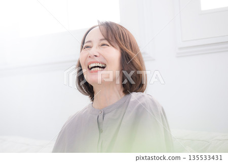 Smiling senior woman, smiling with a sense of relief, I'll do my best to cope with menopause! Close-up Smiling senior woman, smiling with a sense of relief, I'll do my best to cope with menopause! Close-up 135533431