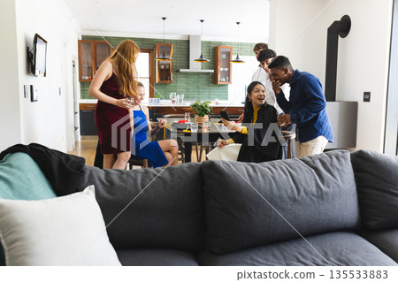 Teen friends enjoying lively conversation and snacks at home party gathering Teen friends enjoying lively conversation and snacks at home party gathering 135533883