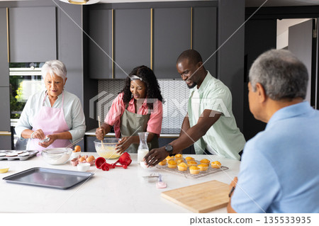 Family baking together in modern kitchen, preparing cupcakes with joy and teamwork Family baking together in modern kitchen, preparing cupcakes with joy and teamwork 135533935