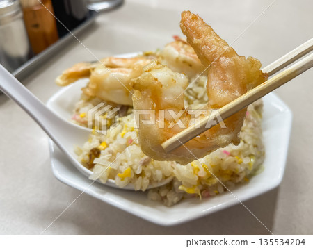 Shrimp fried rice. Fried rice topped with shrimp tempura. 135534204