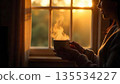 A woman enjoying coffee at a window, symbolizing love and support, reflecting the essence of kindness and community 135534227