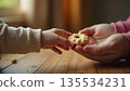 A child proudly displays a cookie held by an adult's hands, highlighting themes of kindness, empathy, and community 135534231