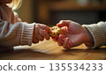 A child and adult share a moment, with the child holding a cookie, embodying generosity and community support 135534233