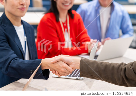 A businessman shaking hands in the office A businessman shaking hands in the office 135534634