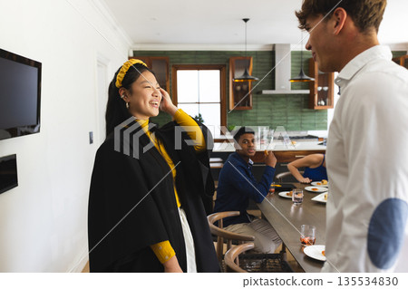 Asian girl laughing with friends at home during joyful celebration Asian girl laughing with friends at home during joyful celebration 135534830