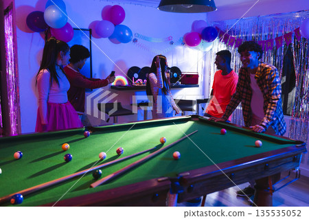 Teenagers celebrating at home, playing pool and taking photos with friends Teenagers celebrating at home, playing pool and taking photos with friends 135535052