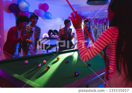Playing pool and dancing, teenagers celebrating vibrant birthday party with friends Playing pool and dancing, teenagers celebrating vibrant birthday party with friends 135535057