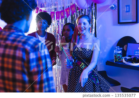Celebrating birthday, teenagers with colorful decorations, joyful in party atmosphere Celebrating birthday, teenagers with colorful decorations, joyful in party atmosphere 135535077