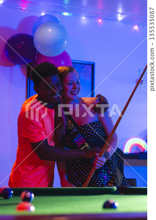 Teenagers celebrating birthday playing pool, smiling and enjoying party atmosphere 135535087