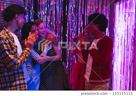 Teenagers celebrating together at party, clapping and smiling with joy Teenagers celebrating together at party, clapping and smiling with joy 135535115