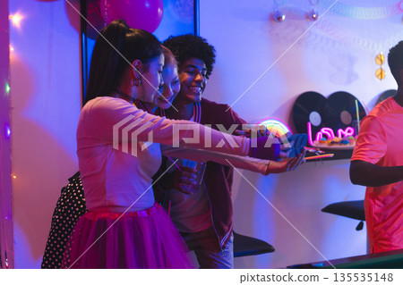 Teen friends taking selfies at vibrant party, enjoying fun and laughter together Teen friends taking selfies at vibrant party, enjoying fun and laughter together 135535148