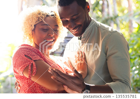 African American couple laughing and enjoying joyful moment together outdoors African American couple laughing and enjoying joyful moment together outdoors 135535781