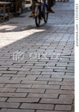 The red brick pavement of Lukang Old Street and the bicycles passing by 135535923