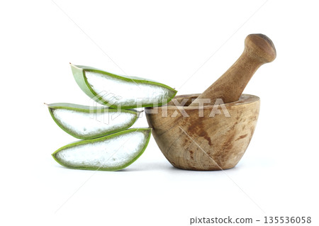 Fresh aloe vera slices and wooden mortar with pestle for natural remedies Fresh aloe vera slices and wooden mortar with pestle for natural remedies 135536058