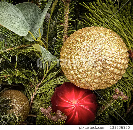 festive arrangement of glittering colorful Christmas ornament balls nestled in lush evergreen branches, creating a warm, celebratory mood perfect for holiday decor and seasonal stock photography festive arrangement of glittering colorful Christmas ornament balls nestled in lush evergreen branches, creating a warm, celebratory mood perfect for holiday decor and seasonal stock photography 135536530
