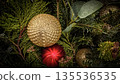 festive arrangement of glittering colorful Christmas ornament balls nestled in lush evergreen branches, creating a warm, celebratory mood perfect for holiday decor and seasonal stock photography 135536535