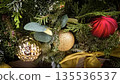 festive arrangement of glittering colorful Christmas ornament balls nestled in lush evergreen branches, creating a warm, celebratory mood perfect for holiday decor and seasonal stock photography 135536537