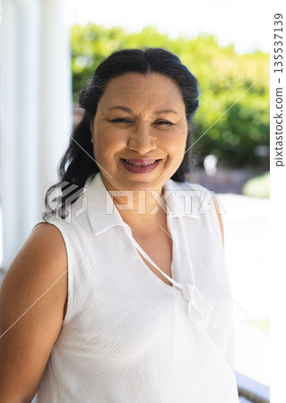 Smiling senior woman enjoying sunny day outdoors, embracing joyful moments Smiling senior woman enjoying sunny day outdoors, embracing joyful moments 135537139