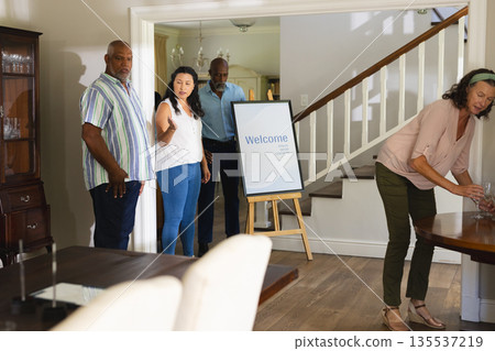 Family gathering at home, people preparing for celebration with welcome sign Family gathering at home, people preparing for celebration with welcome sign 135537219
