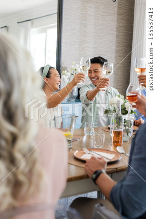 Toasting wine glasses, friends celebrating wedding and smiling together outdoors Toasting wine glasses, friends celebrating wedding and smiling together outdoors 135537413