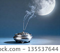 Incense burning with the moon in the background 135537644