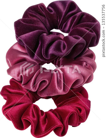 Three soft velvet scrunchies in a gradient of rich purple to pink shades 135537756