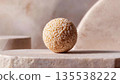 Minimalist art food composition expressing calm emotion, perfectly round rice sphere placed on smooth stone surface 135538222