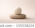 Minimalist art food composition expressing calm emotion, perfectly round rice sphere placed on smooth stone surface 135538224