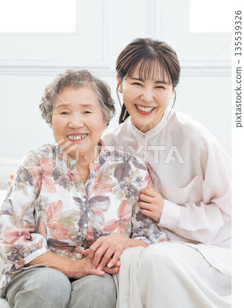 Grandma and granddaughter cuddling Grandma and granddaughter cuddling 135539326