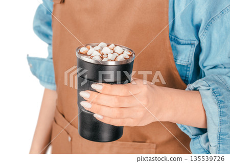 Woman holding reusable cup of hot chocolate with marshmallows on white background 135539726