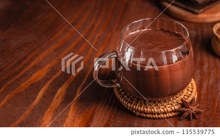 Glass cup of hot chocolate on wooden table with copy space Glass cup of hot chocolate on wooden table with copy space 135539775