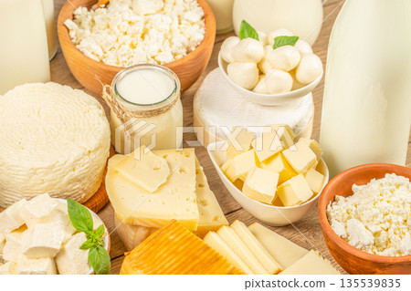 Fresh dairy products assortment with cheese, milk, butter and mozzarella on wooden table 135539835