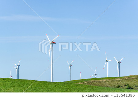A wind power plant towering over a hill (image of natural energy) 135541390