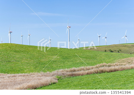 A wind power plant towering over a hill (image of natural energy) 135541394