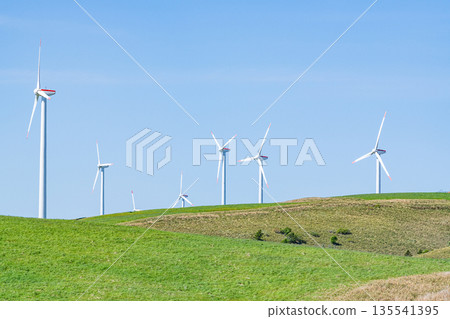A wind power plant towering over a hill (image of natural energy) 135541395