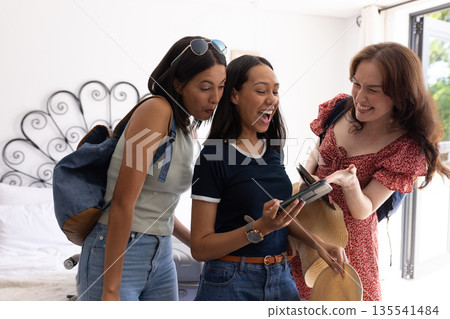Laughing and sharing moment, three women gather around smartphone at home Laughing and sharing moment, three women gather around smartphone at home 135541484