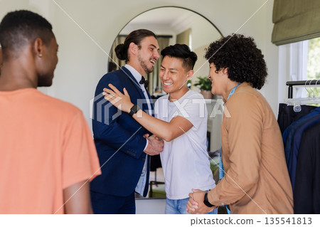 Greeting each other warmly, friends sharing joyful moments before wedding celebration Greeting each other warmly, friends sharing joyful moments before wedding celebration 135541813