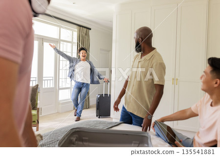 Arriving with luggage in hotel room, friends preparing for wedding celebration 135541881