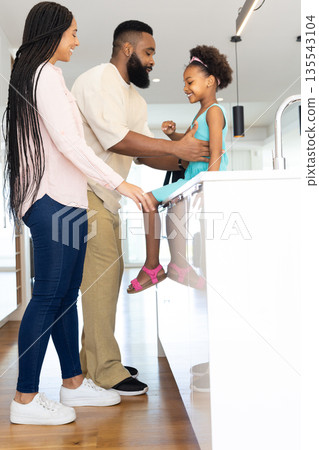 Happy family enjoying quality time together in modern kitchen at home Happy family enjoying quality time together in modern kitchen at home 135543104