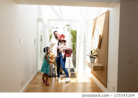 Family enjoying sunny day at home, parents and child smiling with teddy bear Family enjoying sunny day at home, parents and child smiling with teddy bear 135543164
