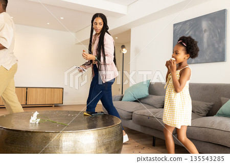 African American mother and daughter enjoying playful moment at home together 135543285