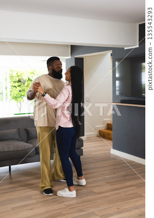 African American couple dancing together at home, enjoying joyful moment African American couple dancing together at home, enjoying joyful moment 135543293