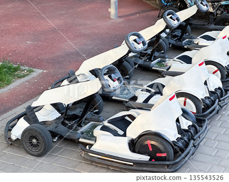 Row of parked go-karts ready for racing adventure. 135543526